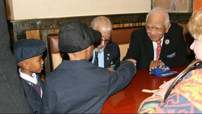 photo-106 - christian and alphonza gibbs greet tuskeegee airmen val archer and wilbur mason