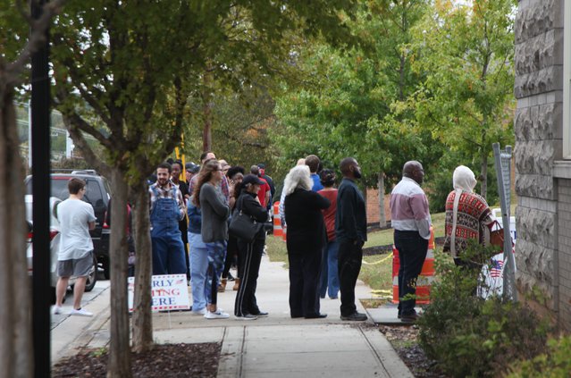 voters wait outside the county administration building to vote friday.jpg